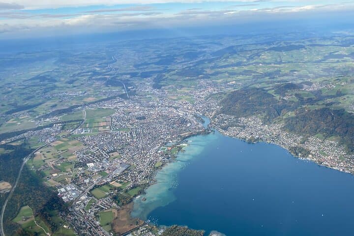 The color differences of Lake Thun are unique when seen from a helicopter. The green fields and white mountain peaks around are a beautiful sight