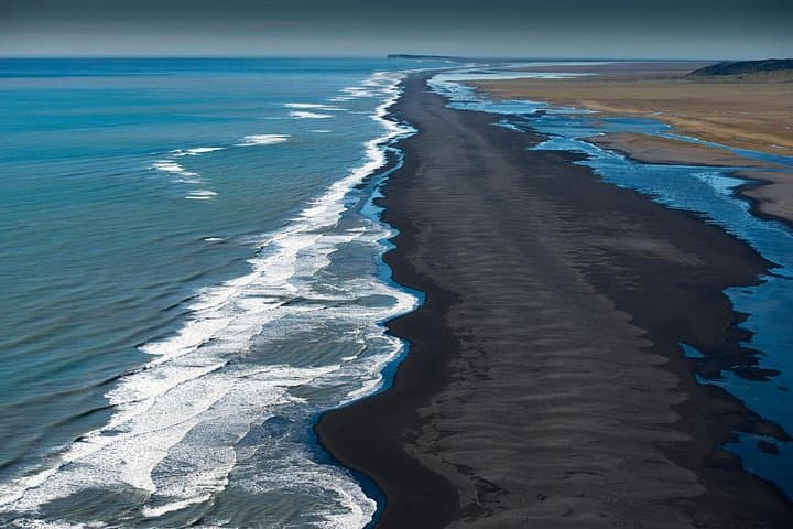 Endless black sand beaches in the South Coast of Iceland from the air.