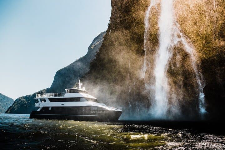 Sit beneath the towering falls in Milford Sound